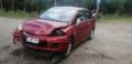 Kuva 1: Nissan Tiida 1,5 DCI -09 punainen 5-ov HB 2009