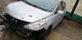 Kuva 1: Nissan Tiida 1,5 DCI--09 5-ov HB harmaa 2009